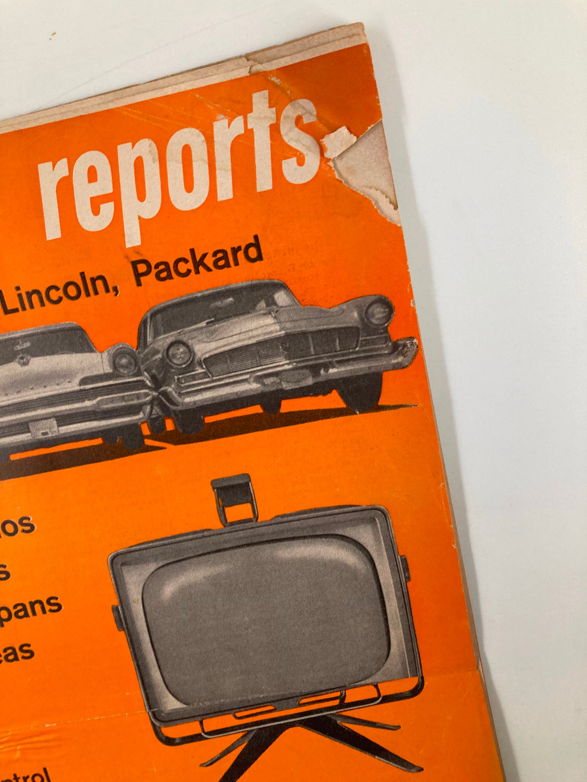 Close-up of the cover of Vintage Consumer Reports Magazine August 1956 highlighting Chrysler, Lincoln, and Packard vehicles, reflecting mid-20th century automotive designs.