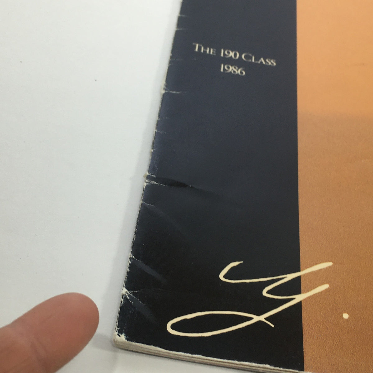 Side view of the 1986 Mercedes-Benz 190 Class Dealership Car Auto Brochure Catalog showing wear details and the signature 'Y. Daimler' with the year 1986.
