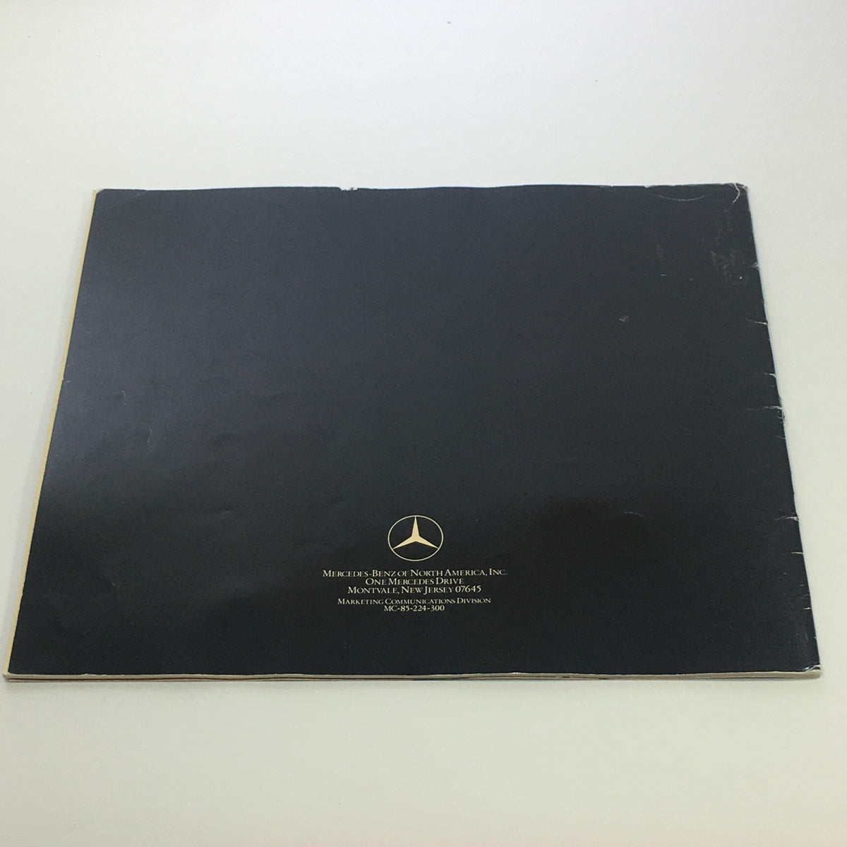 Back cover of the 1986 Mercedes-Benz 190 Class Dealership Car Auto Brochure Catalog, featuring the Mercedes-Benz logo and branding.
