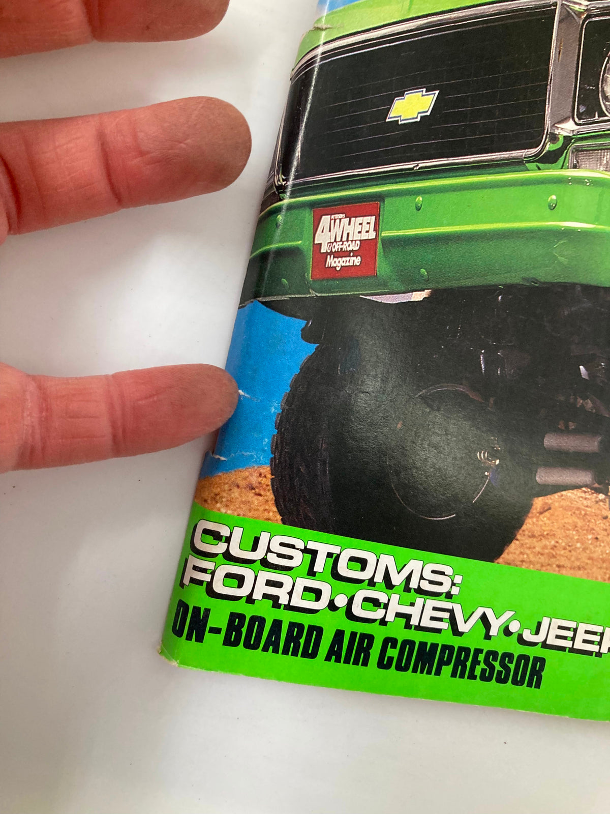 Close-up of the cover of Petersen's 4 Wheel & Off-Road Magazine April 1988, showcasing the Chevrolet logo and magazine title with highlighted sections about customs for Ford, Chevy, and Jeep.