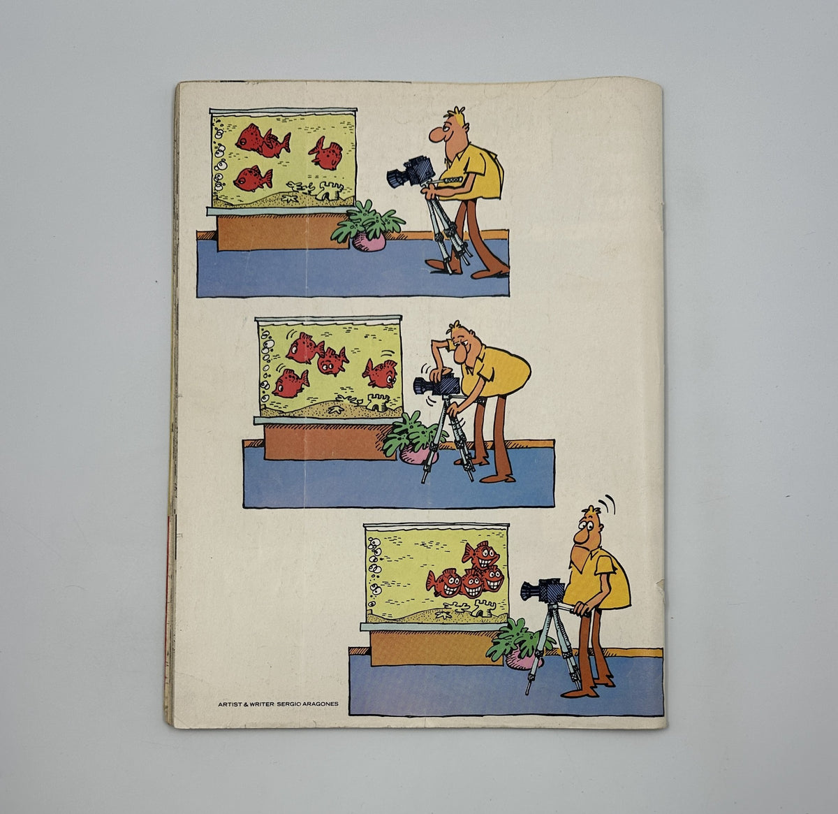 Back cover illustration of MAD Magazine No. 205 March 1979, depicting a humorous cartoon about a man photographing fish, highlighting the magazine's comedic style in Very Good condition.