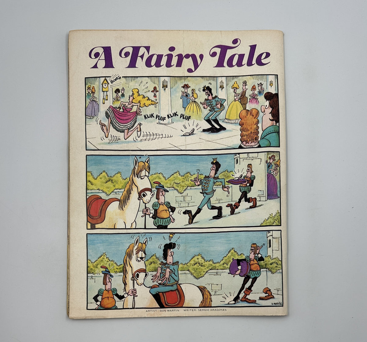 Cover illustration of MAD Magazine No. 195 December 1977 featuring a comic strip titled 'A Fairy Tale' showing whimsical characters and humorous scenes. The comic-style art includes vibrant colors and playful interactions among characters, characteristic of MAD Magazine's satire. The issue includes content related to movie satires like 'Blimp Sunday' and 'Airplot ’77', and is graded Very Good (VG 4.0).