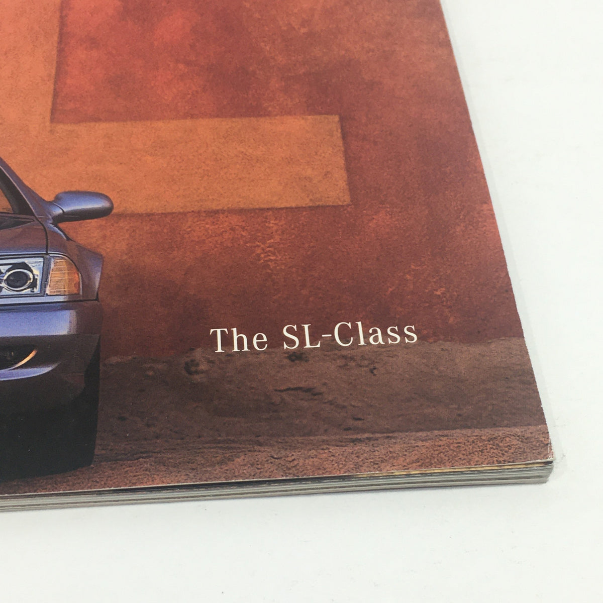 Cover image of the 1999 Mercedes-Benz SL-Class Sport Package Dealership Car Auto Brochure Catalog, featuring the SL-Class title prominently displayed.