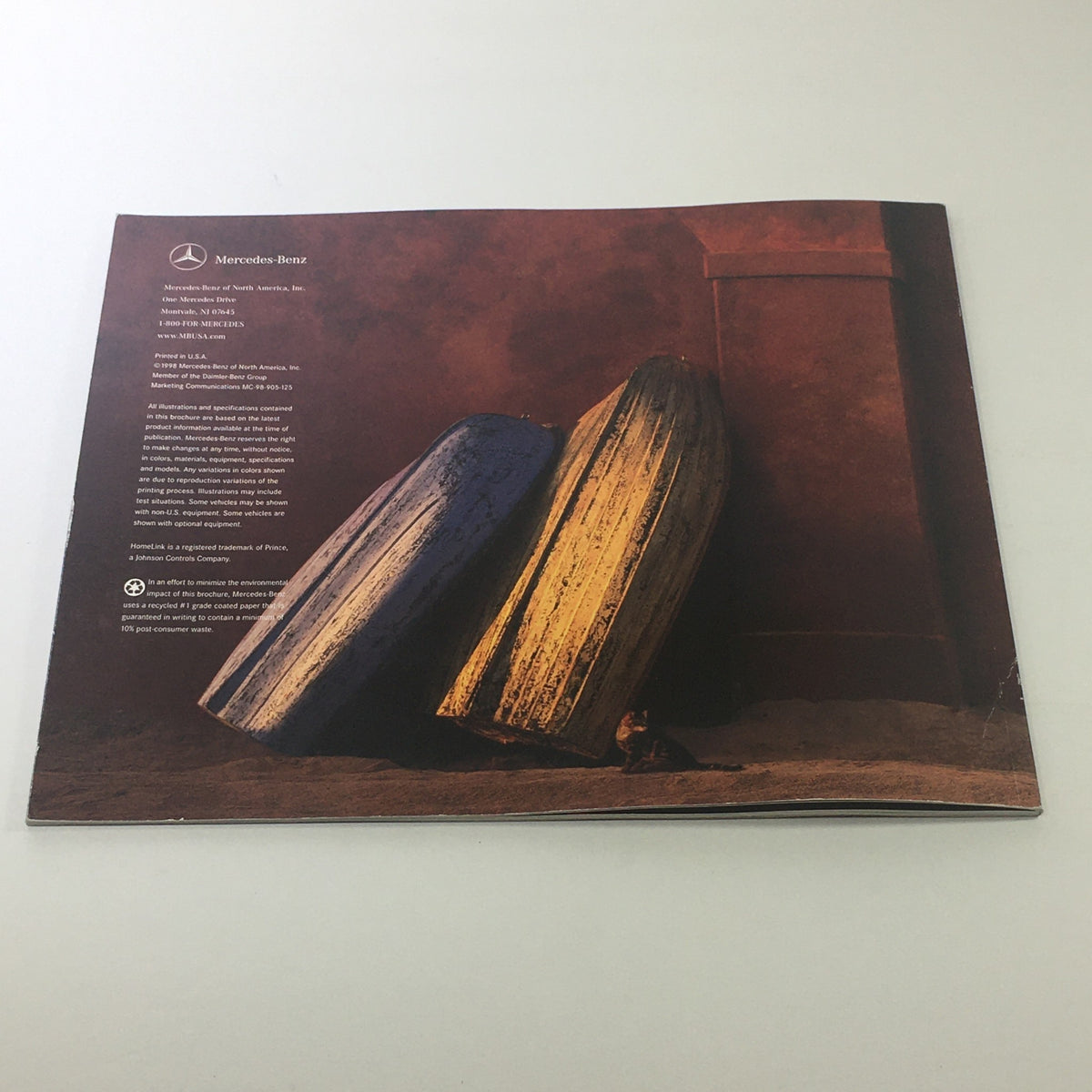 Back cover of the 1999 Mercedes-Benz SL-Class Sport Package Dealership Car Auto Brochure Catalog, showcasing artistic imagery and brand details.