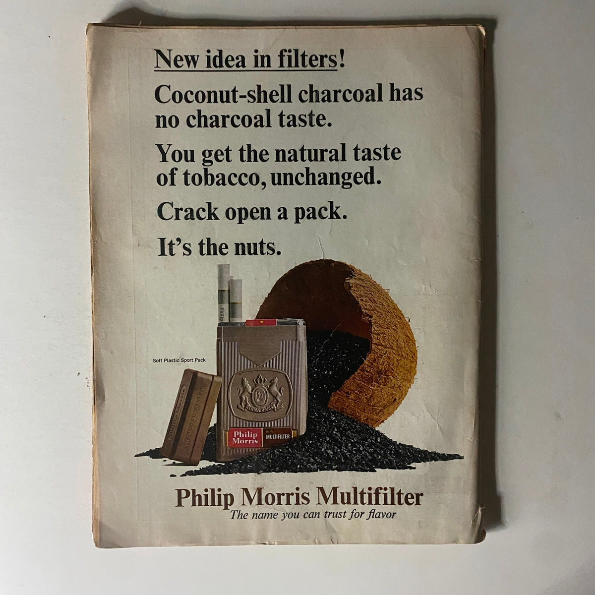 Advertisement for Philip Morris Multifilter cigarettes from a vintage magazine, highlighting the benefits of coconut-shell charcoal filters, from the Time Magazine December 18, 1964 issue.