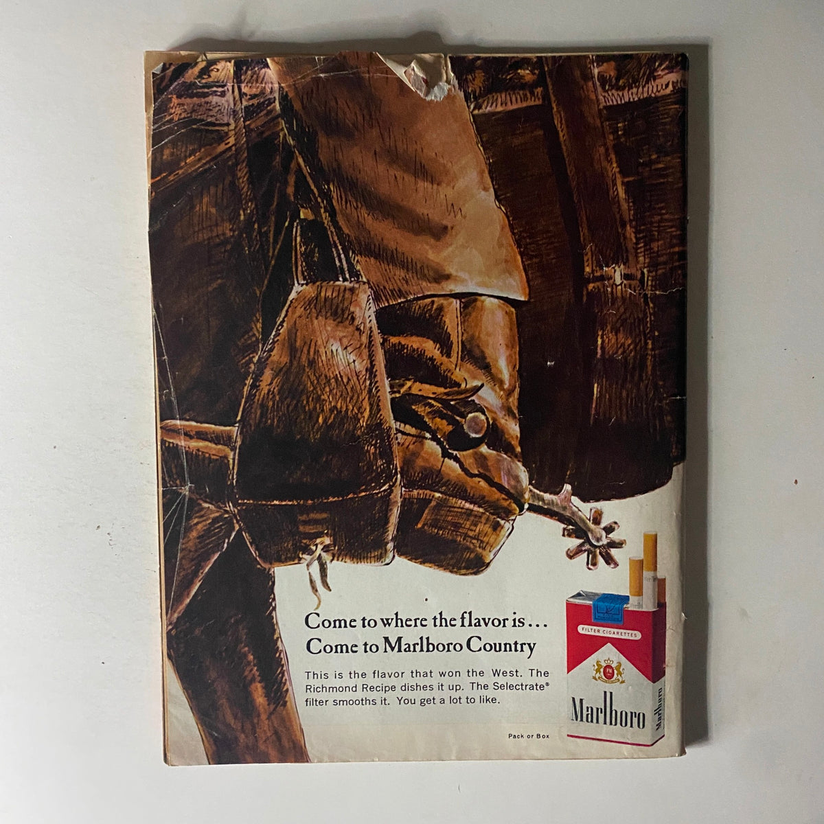 Back cover of Time Magazine November 27, 1964, Vol 84 No. 22 with an advertisement for Marlboro cigarettes featuring a rustic, engaging illustration.