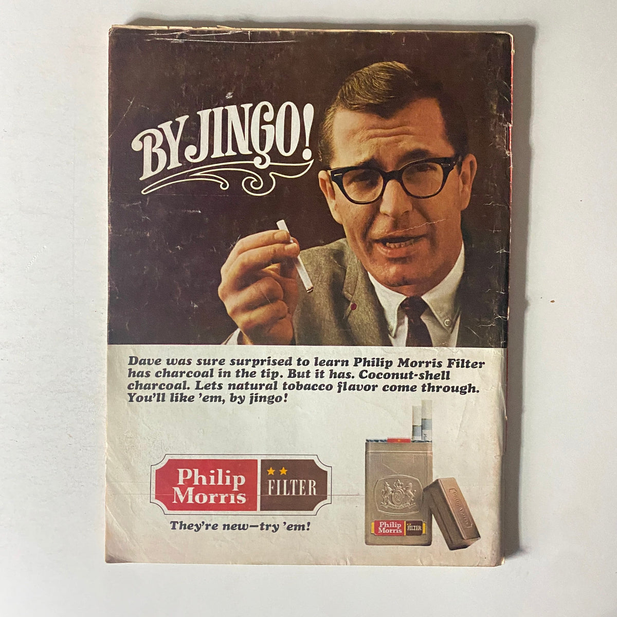Vintage advertisement for Philip Morris Filter cigarettes, showcasing a man with glasses promoting the product with the phrase 'By Jingo!', reflecting mid-20th century advertising style.
