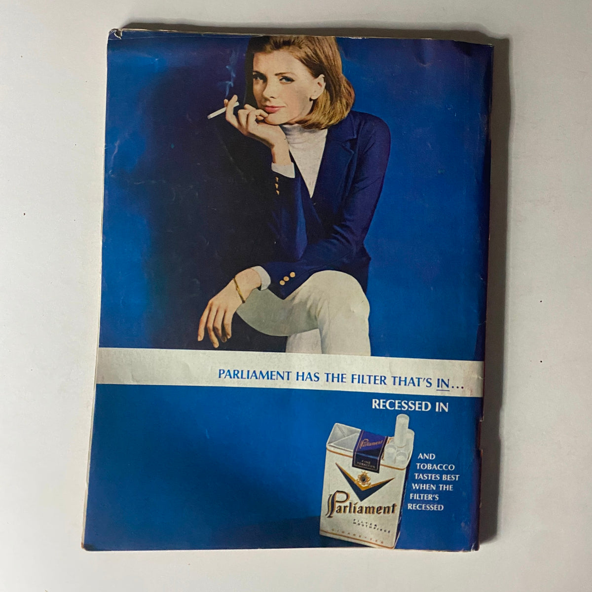 Vintage advertisement for Parliament cigarettes featuring a woman smoking, emphasizing the slogan about the recessed filter, on the back cover of Time Magazine dated October 22, 1965.