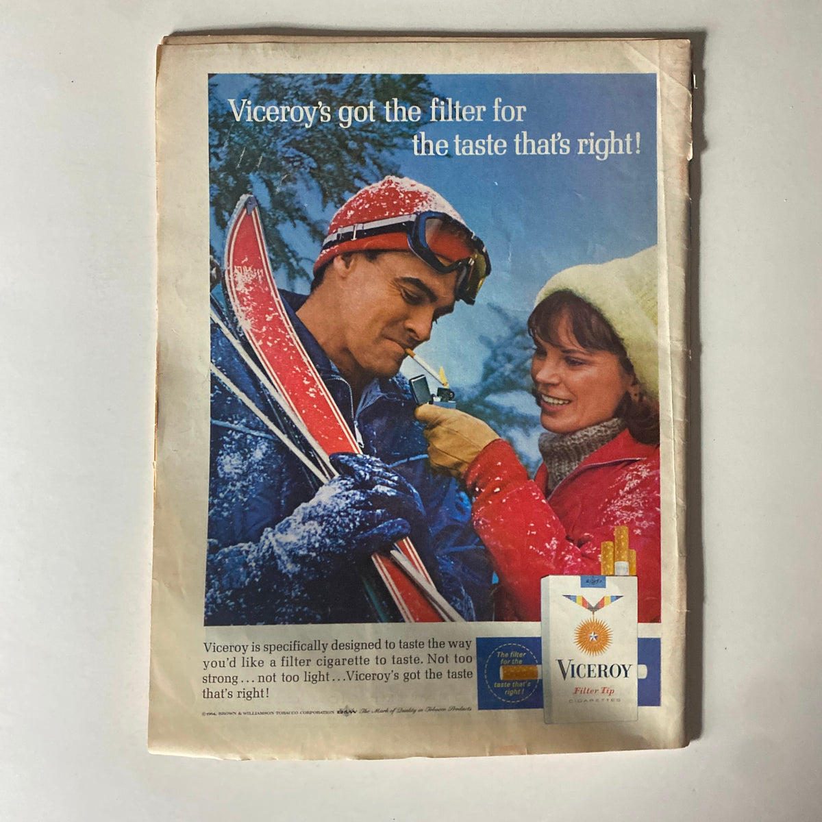 An advertisement from a vintage magazine showcasing Viceroy cigarettes with a snowy background, featuring a man and woman skiing, promoting the tagline 'Viceroy's got the filter for the taste that's right!'
