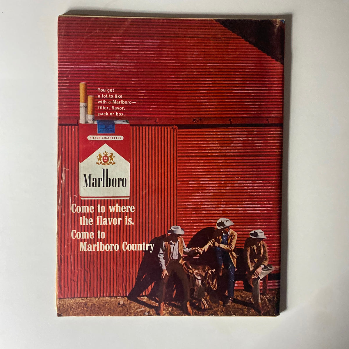 Vintage advertisement for Marlboro Cigarettes on the back cover of Time Magazine May 7, 1965, showcasing the slogan 'Come to where the flavor is. Come to Marlboro Country.'