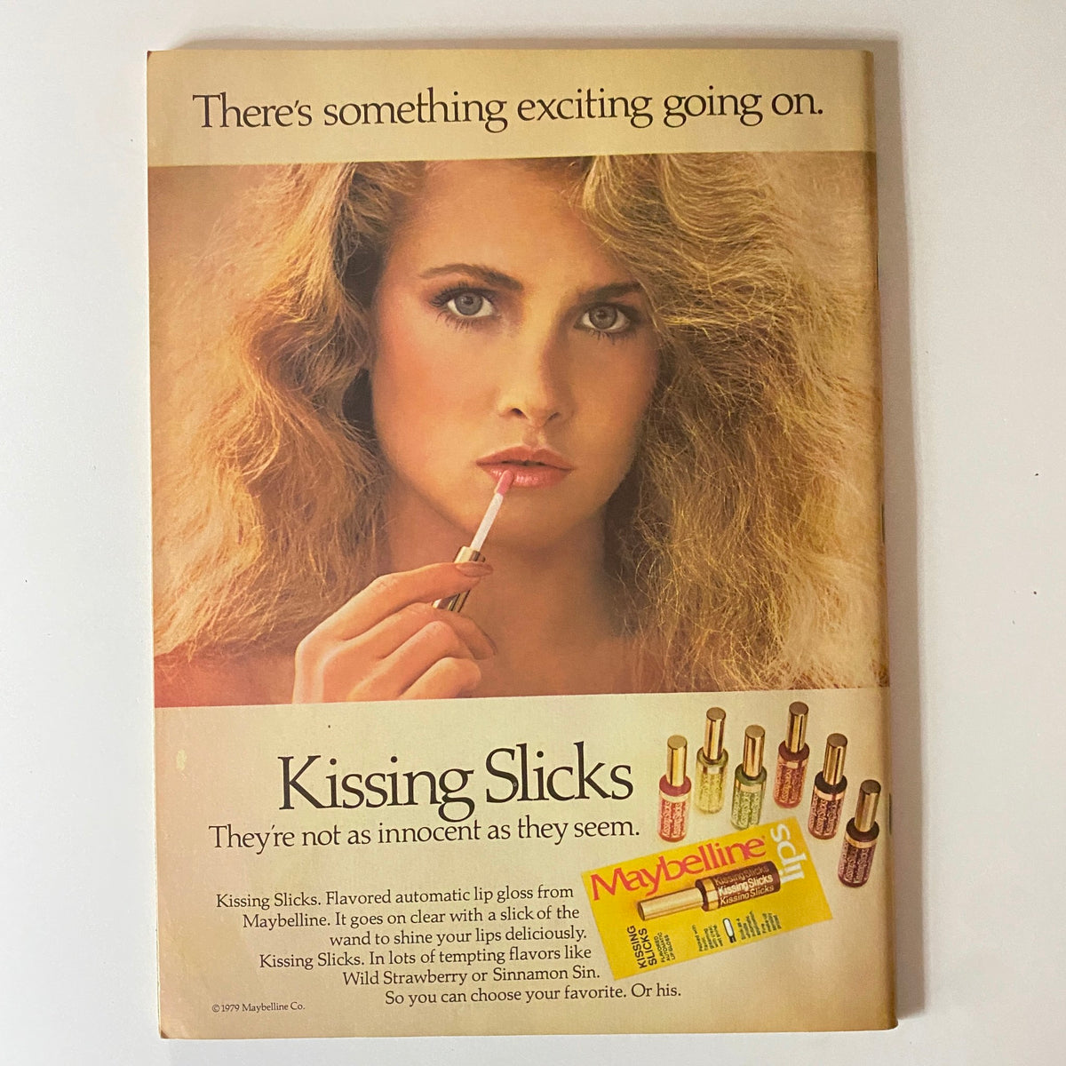 Teen Beat Magazine May 1981 advertisement for Maybelline Kissing Slicks lip gloss, highlighting a model applying lip gloss with a soft expression.