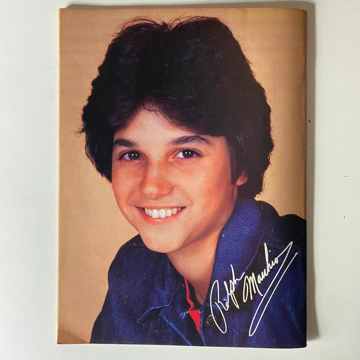 Youthful portrait of Ralph Macchio with an autograph, highlighted in Teen Machine Magazine May 1982, representing teen idol culture.
