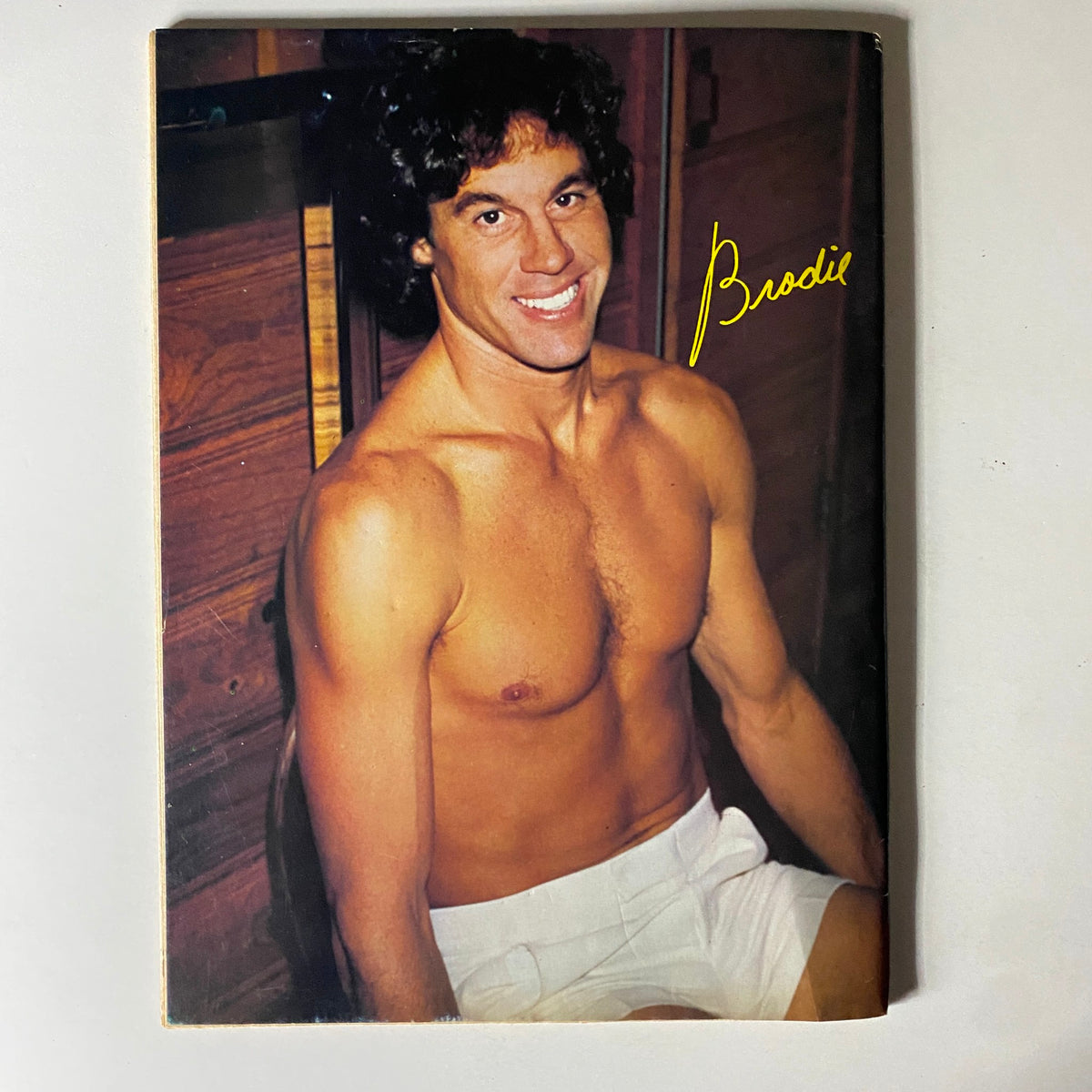 Teen Spectacular Magazine July 1981 image of a muscular male star with curly hair, sitting shirtless, exuding charm and confidence, reflecting the era's teen idol popularity.