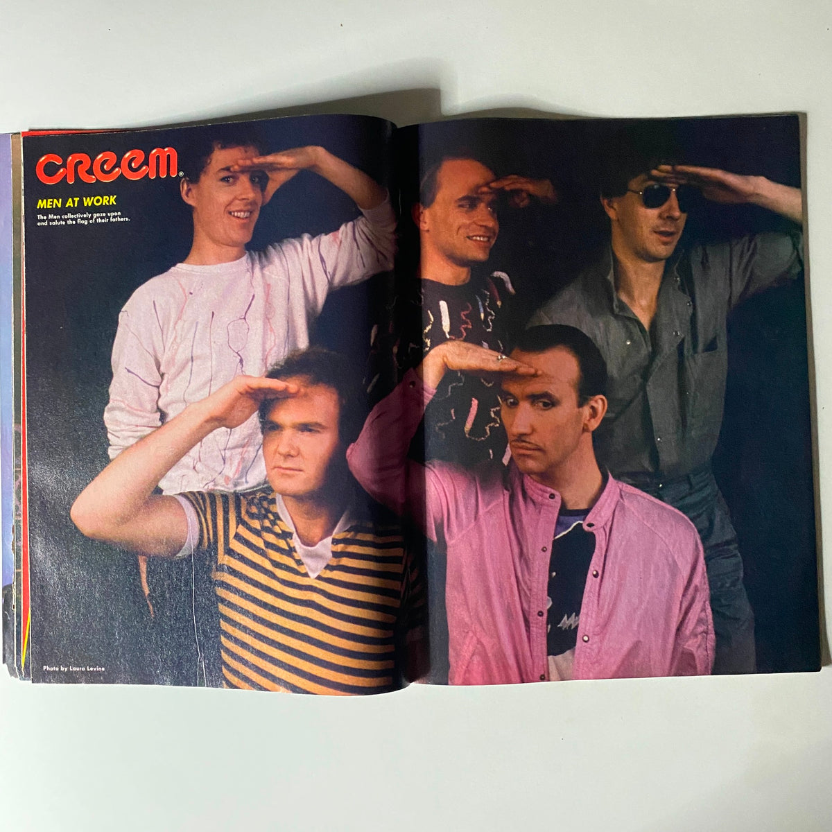 Inside page of the vintage magazine 'Creem Close-Up: Heavy 100, October 1983' featuring the band Men at Work posing creatively with saluting gestures.
