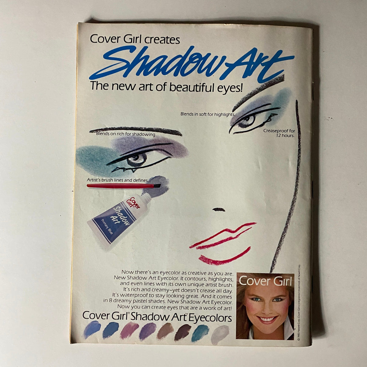 Young Miss Magazine May 1983 - A vintage advertisement for Cover Girl's Shadow Art Eyecolor, showcasing vibrant eye makeup tips and a promotional image of the product with a woman's face illustration.