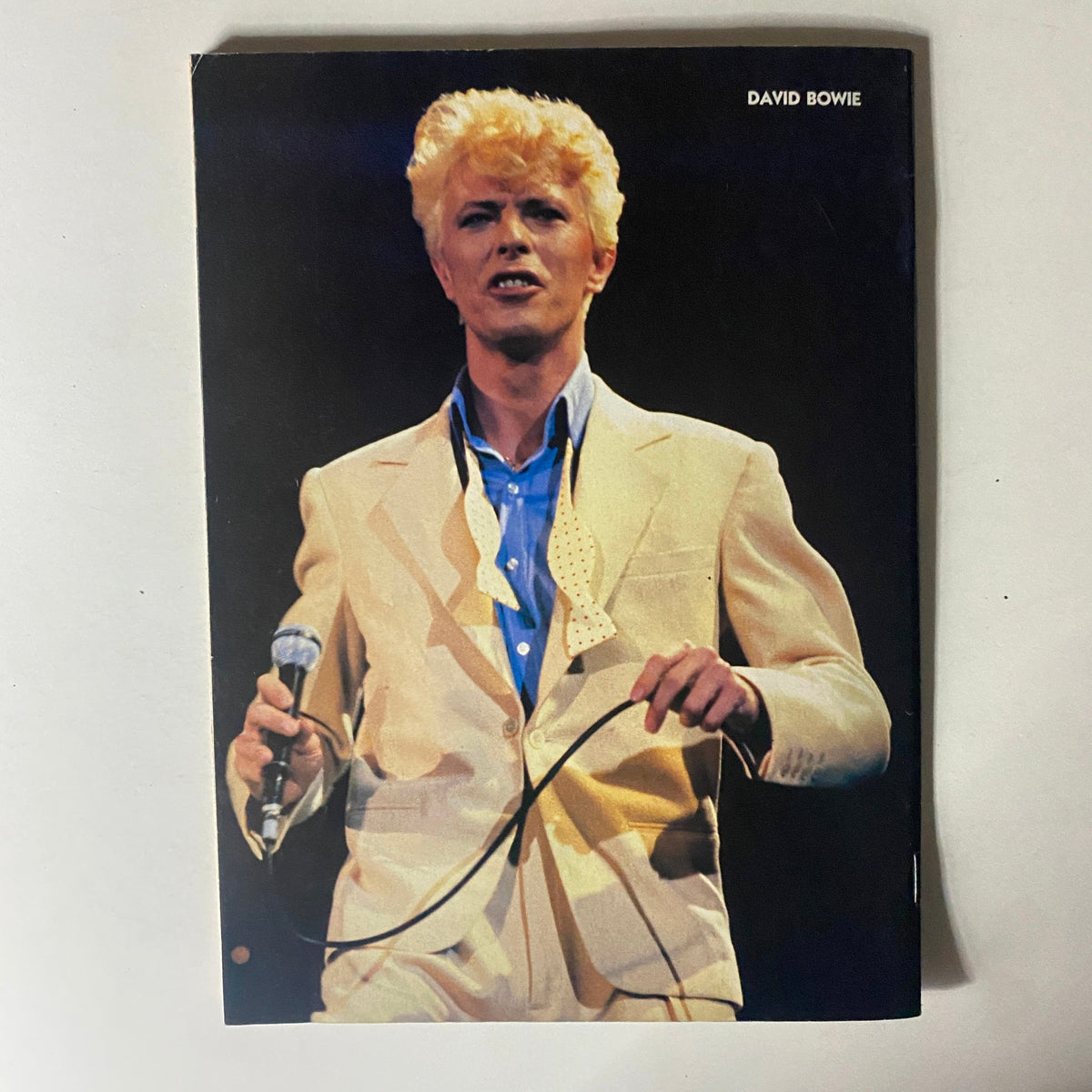 Rock World Magazine May 1984 includes a striking image of David Bowie in a stylish suit, capturing the essence of his iconic stage presence.