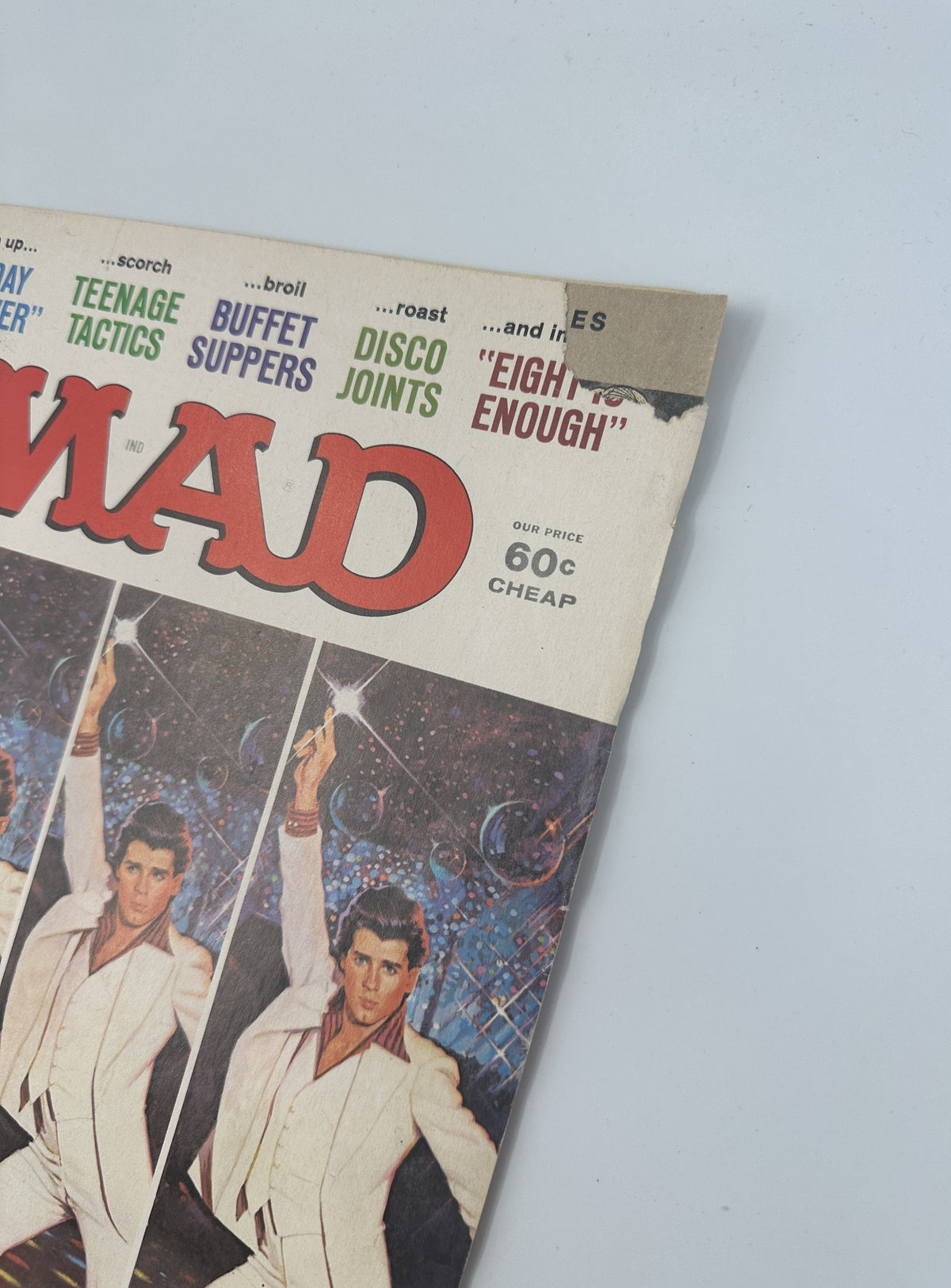 Close-up of the top edge of MAD Magazine No. 201, September 1978, showing the title 'Saturday Night Feeble' along with notable articles including 'Teenage Tactics', 'Buffet Suppers', and 'Disco Joints'. The magazine displays signs of wear, including a small tear.