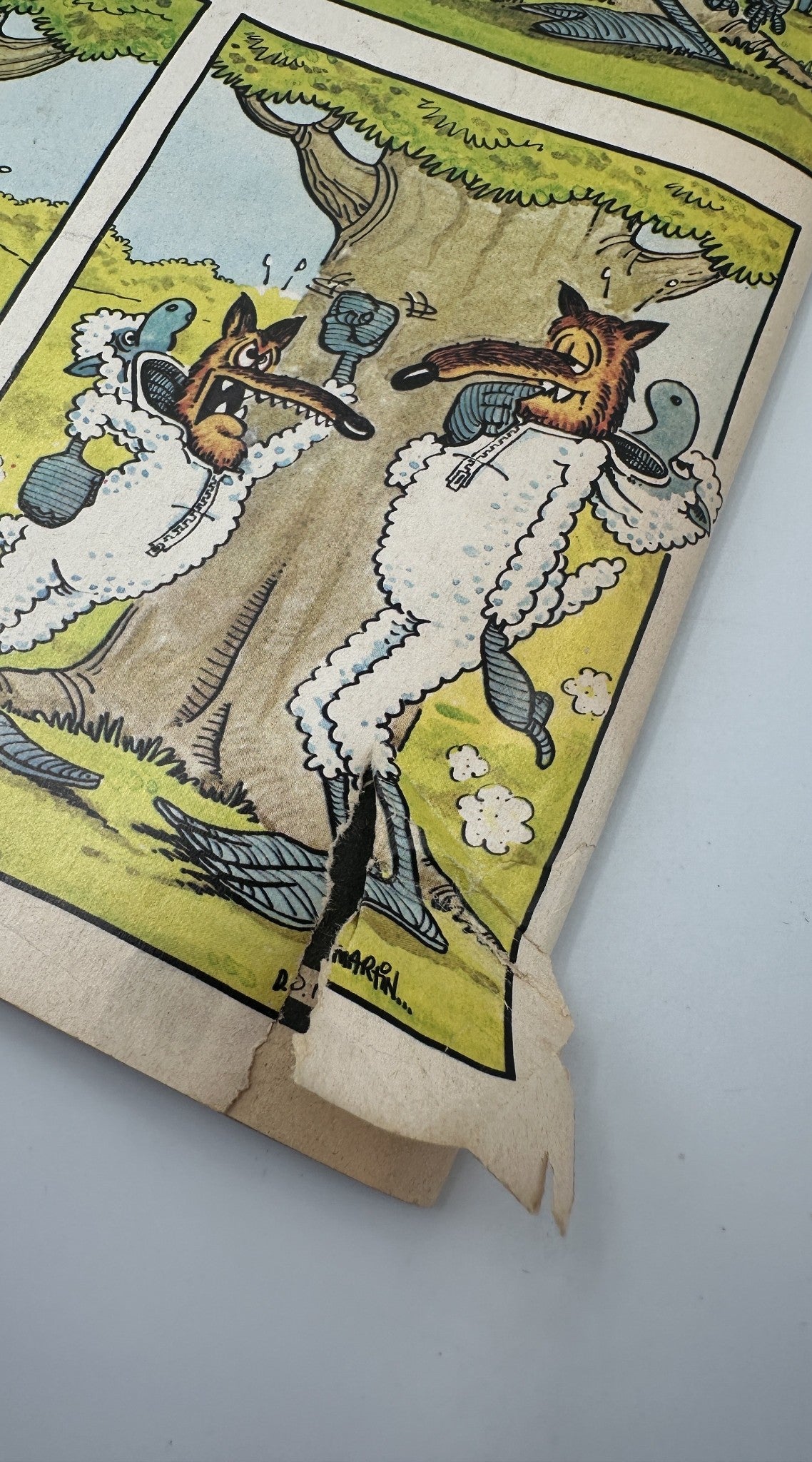 A damaged page from MAD Magazine No. 201, September 1978, illustrating a comic strip featuring characters in costumes with a notable tear along the edge, highlighting its condition.