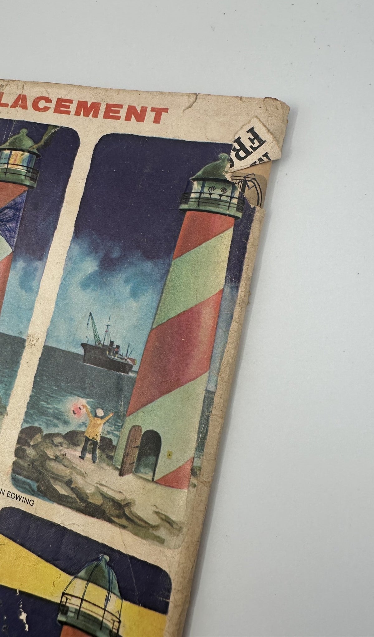 Cover detail of MAD Magazine No. 100 illustrating a lighthouse and a character with a beach ball, highlighting its aged condition with visible creases.