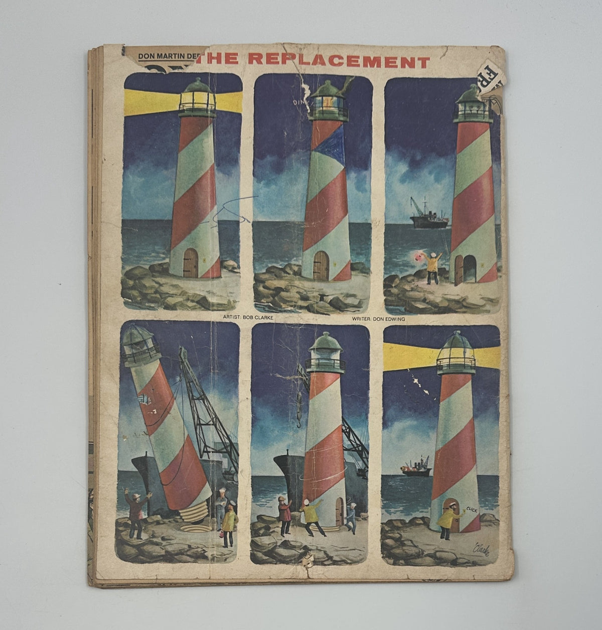 Full cover of MAD Magazine No. 100 depicting multiple lighthouses and characters in a seaside setting, showcasing significant wear and artistic details from January 1966.