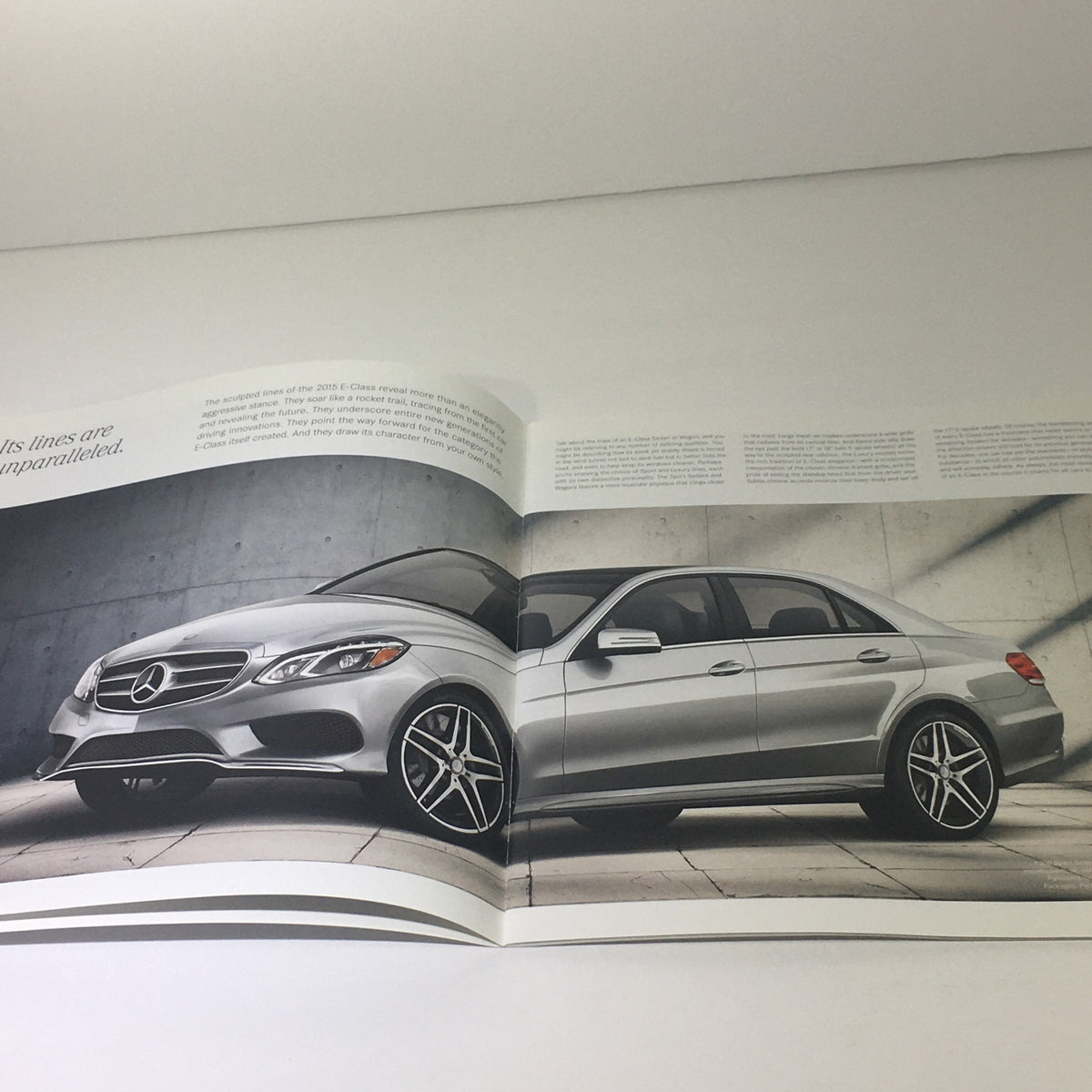 2015 Mercedes-Benz E-Class Sedans & Wagon Dealership Car Auto Brochure Catalog showcasing a silver E-Class sedan in a modern architectural setting.