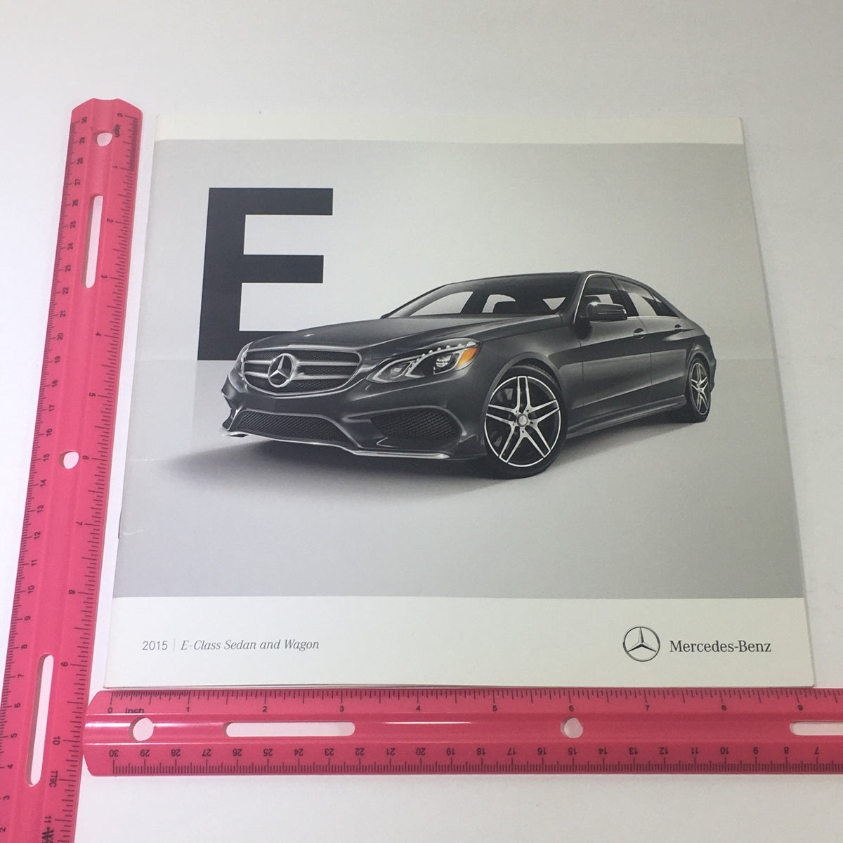 2015 Mercedes-Benz E-Class Sedans & Wagon Dealership Car Auto Brochure featuring a sleek gray vehicle design, showcasing the luxury and performance of the iconic E-Class series.