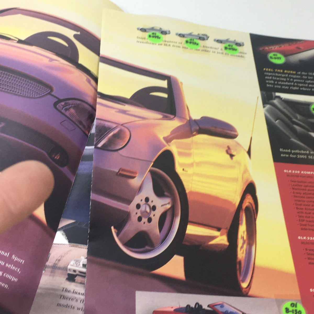 Photograph of the 2001 Mercedes-Benz SLK-Class convertible in action, emphasizing its sleek design and aesthetics. 2001 Mercedes-Benz SLK-Class Dealership Car Auto Brochure Catalog.