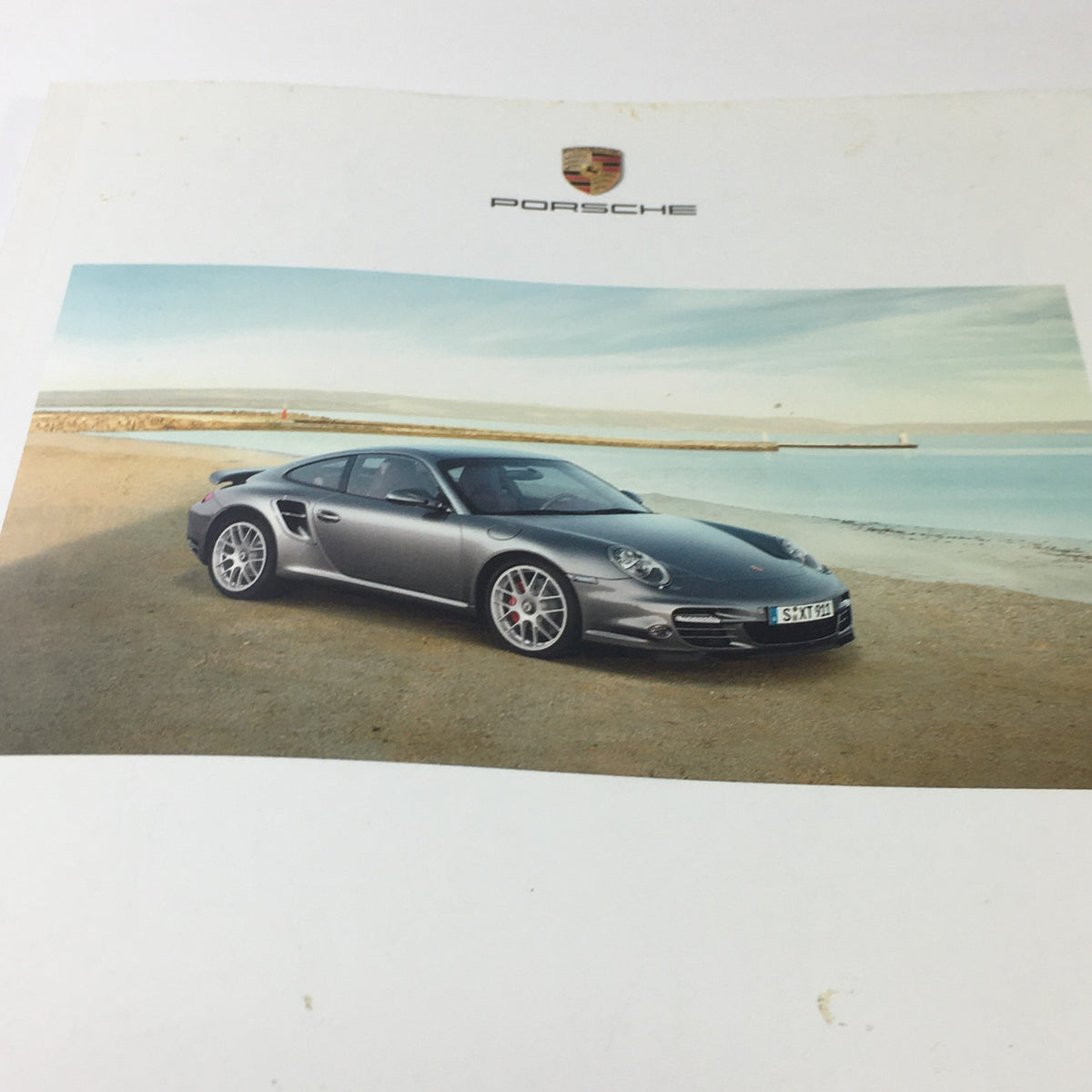 2009 Porsche 911 Turbo Dealership Car Auto Brochure Catalog page showcasing the sleek design and performance features of the Porsche 911 Turbo.