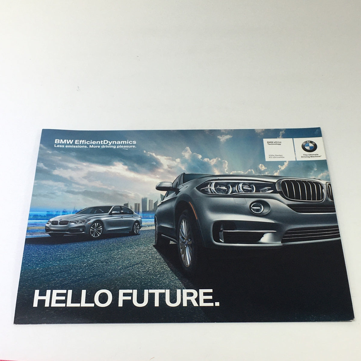2015 BMW eDrive Technology 330e X5 Sedan Dealership Car Auto Brochure Catalog featuring BMW EfficientDynamics, showcasing two vehicles on a scenic road with the tagline 'HELLO FUTURE'.