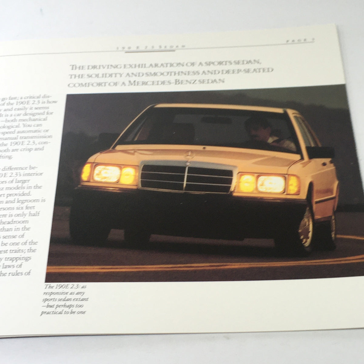 Image of the 1985 Mercedes-Benz 190E 2.3 Sedan displayed in the dealership brochure, emphasizing its design and features.