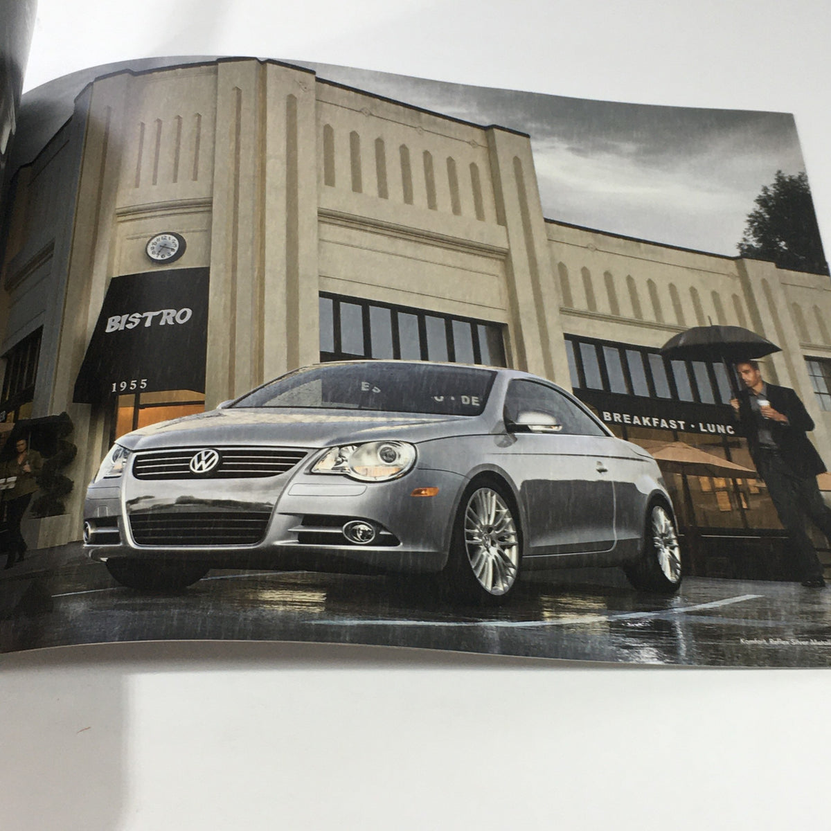 2010 Volkswagen Eos Dos Auto brochure featuring the car parked outside a stylish building, showcasing its modern design.