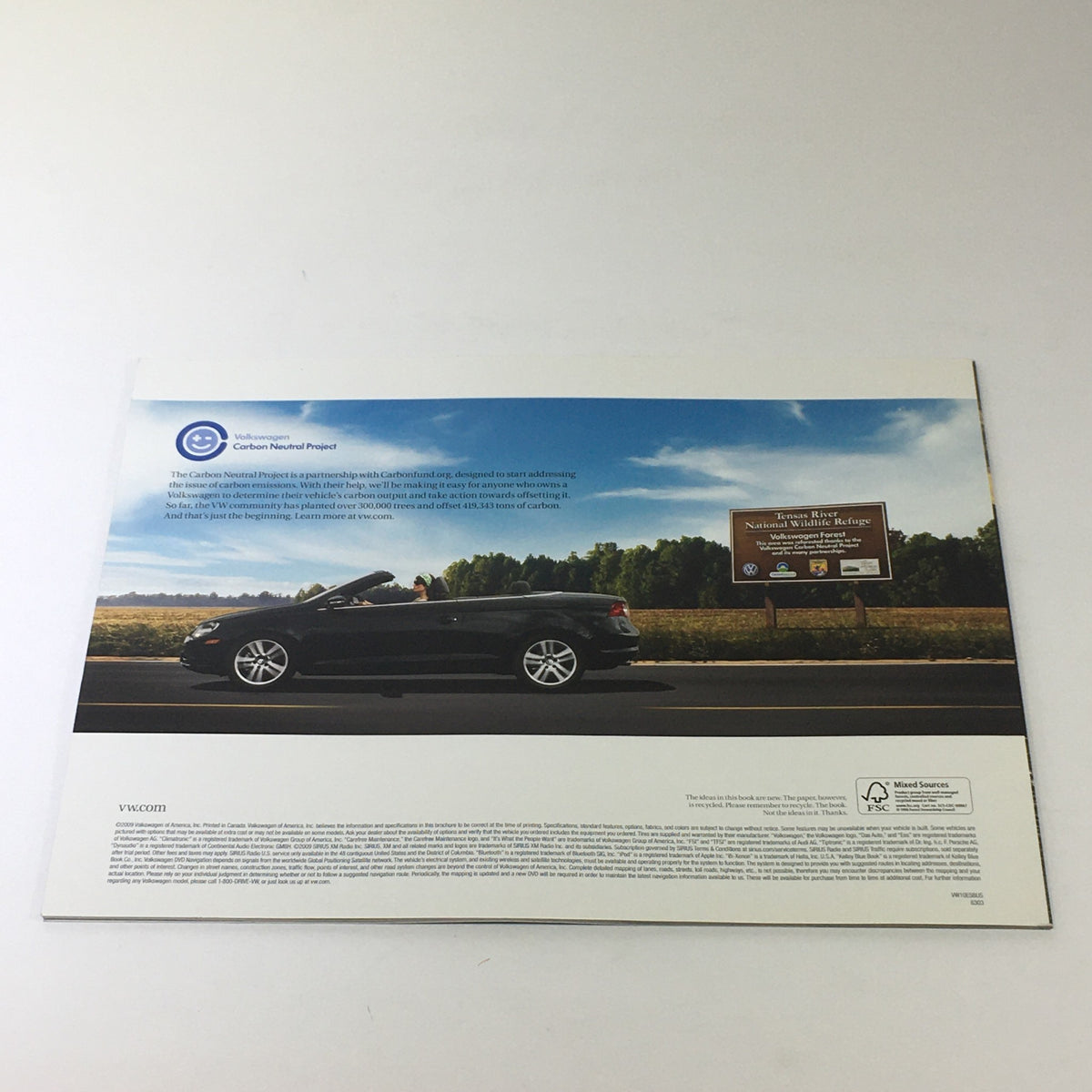 2010 Volkswagen Eos Dos Auto Dealership Car Auto Brochure Catalog featuring a black convertible on a scenic road, showcasing the stylish design and allure of the 2010 Eos model.