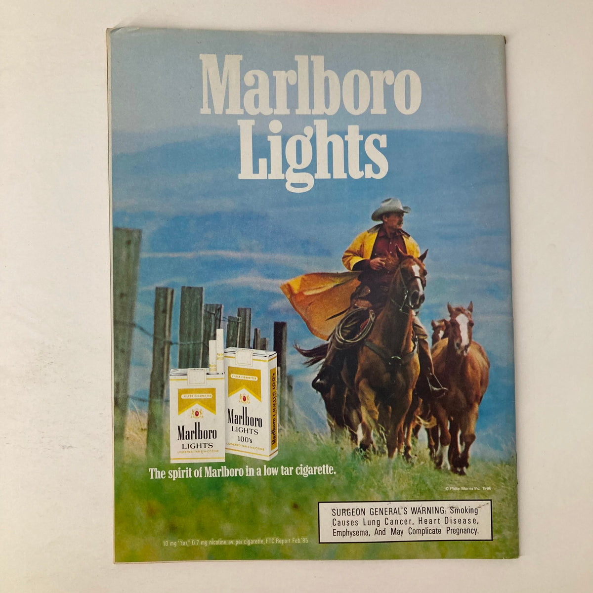 Advertisement from VTG Newsweek Magazine March 3 1986 for Marlboro Lights, showcasing a cowboy on horseback with a scenic background, exemplifying vintage advertising from the 1980s.