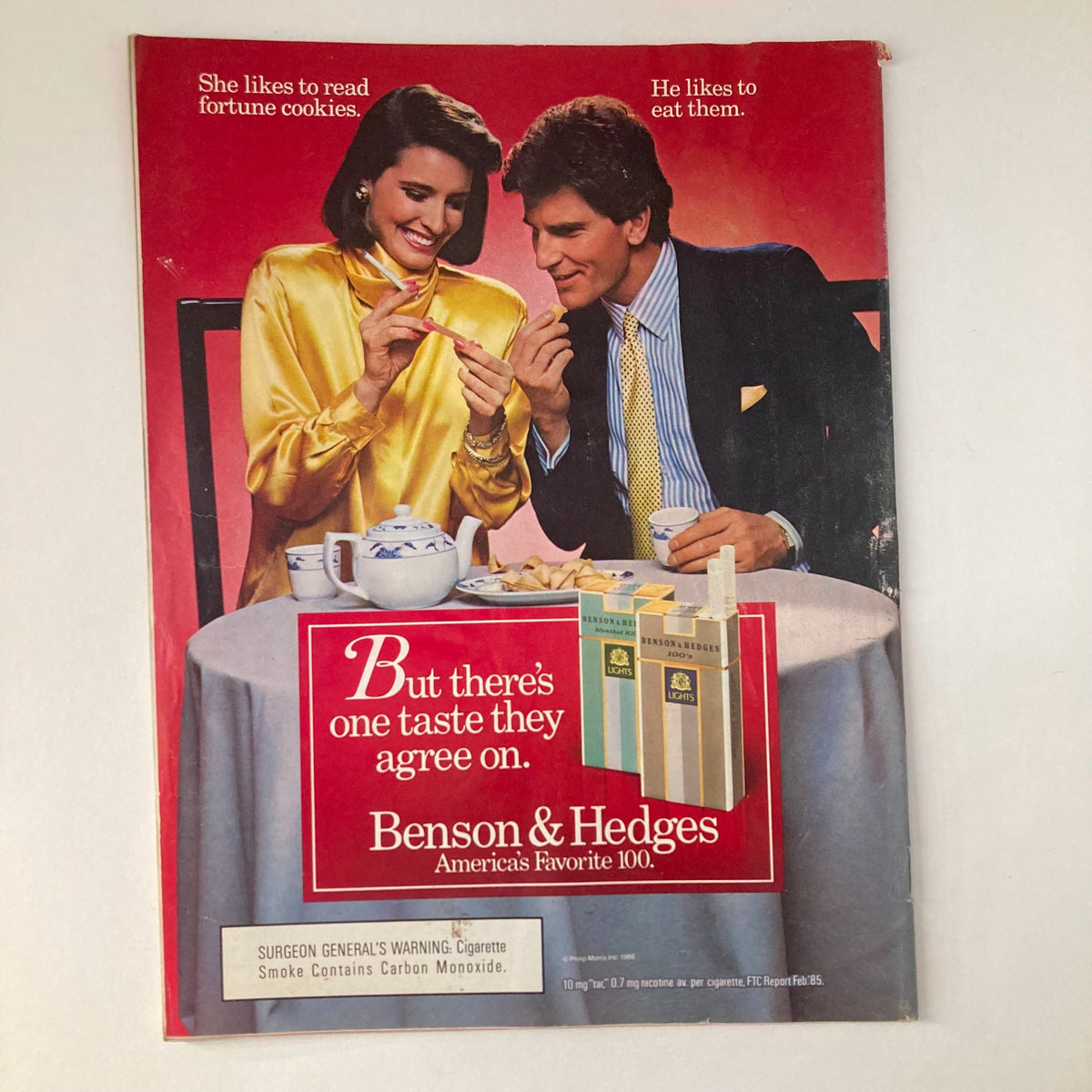 Back cover of the vintage Newsweek magazine from April 14, 1986 featuring an advertisement for Benson & Hedges cigarettes with a couple at a table, symbolizing 1980s advertising aesthetics.