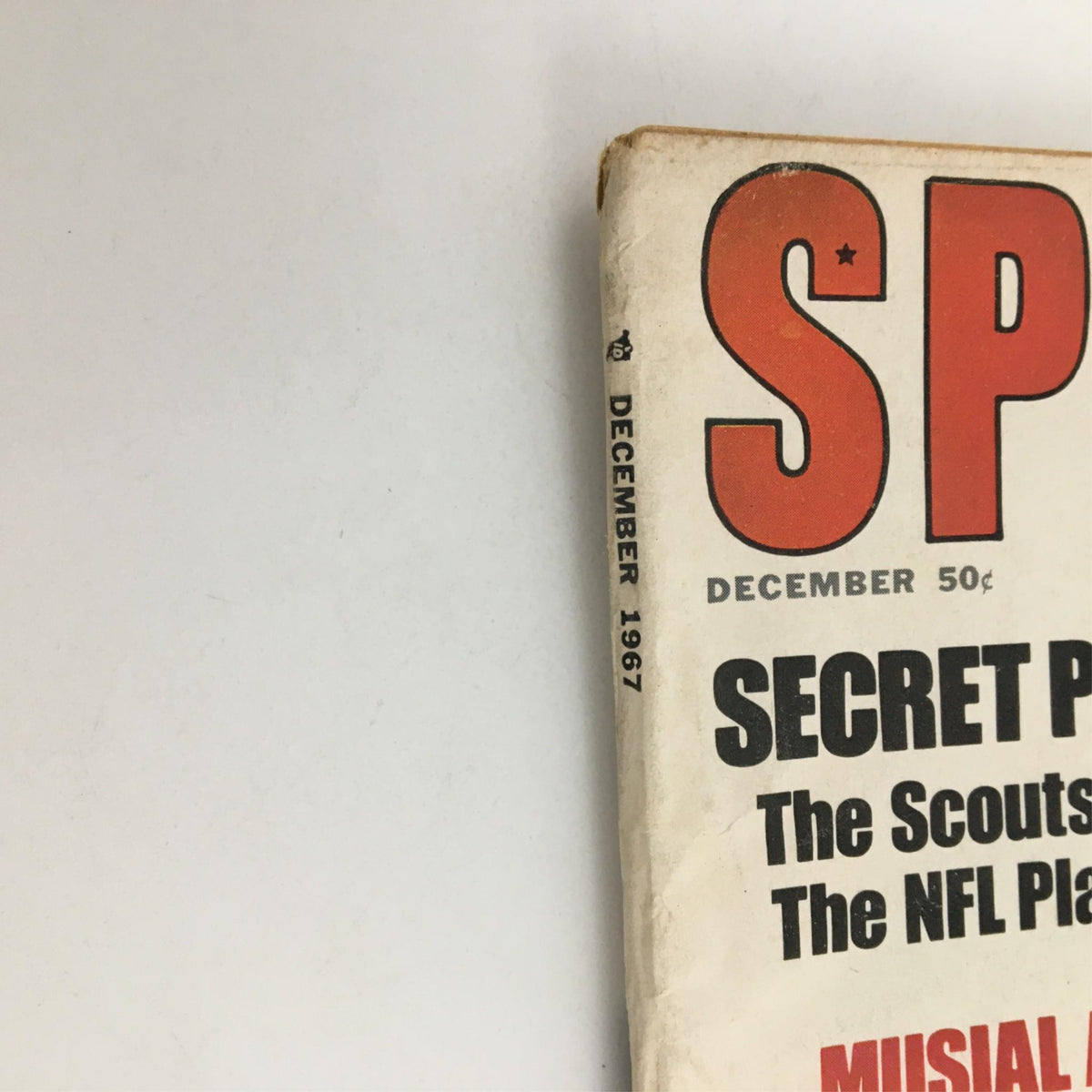 Close-up of the spine of Sport Magazine December 1967, displaying the month and year along with the title and section on NFL players.