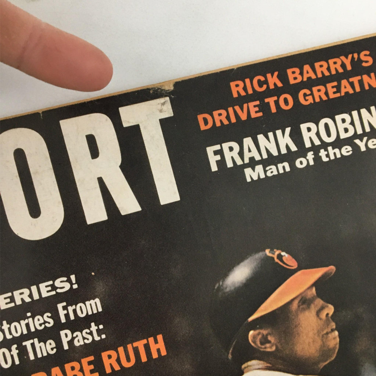 Close-up view of the title and headline on the cover of Sport Magazine February 1967, featuring Frank Robinson and a report about Rick Barry.