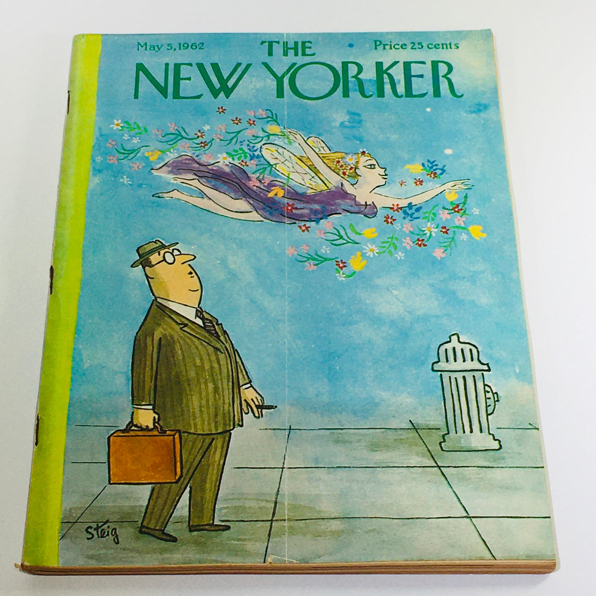 The New Yorker: May 5 1962 Full Magazine theme cover illustrated by William Steig featuring a businessman in a suit looking up at a fairy surrounded by flowers against a blue background.