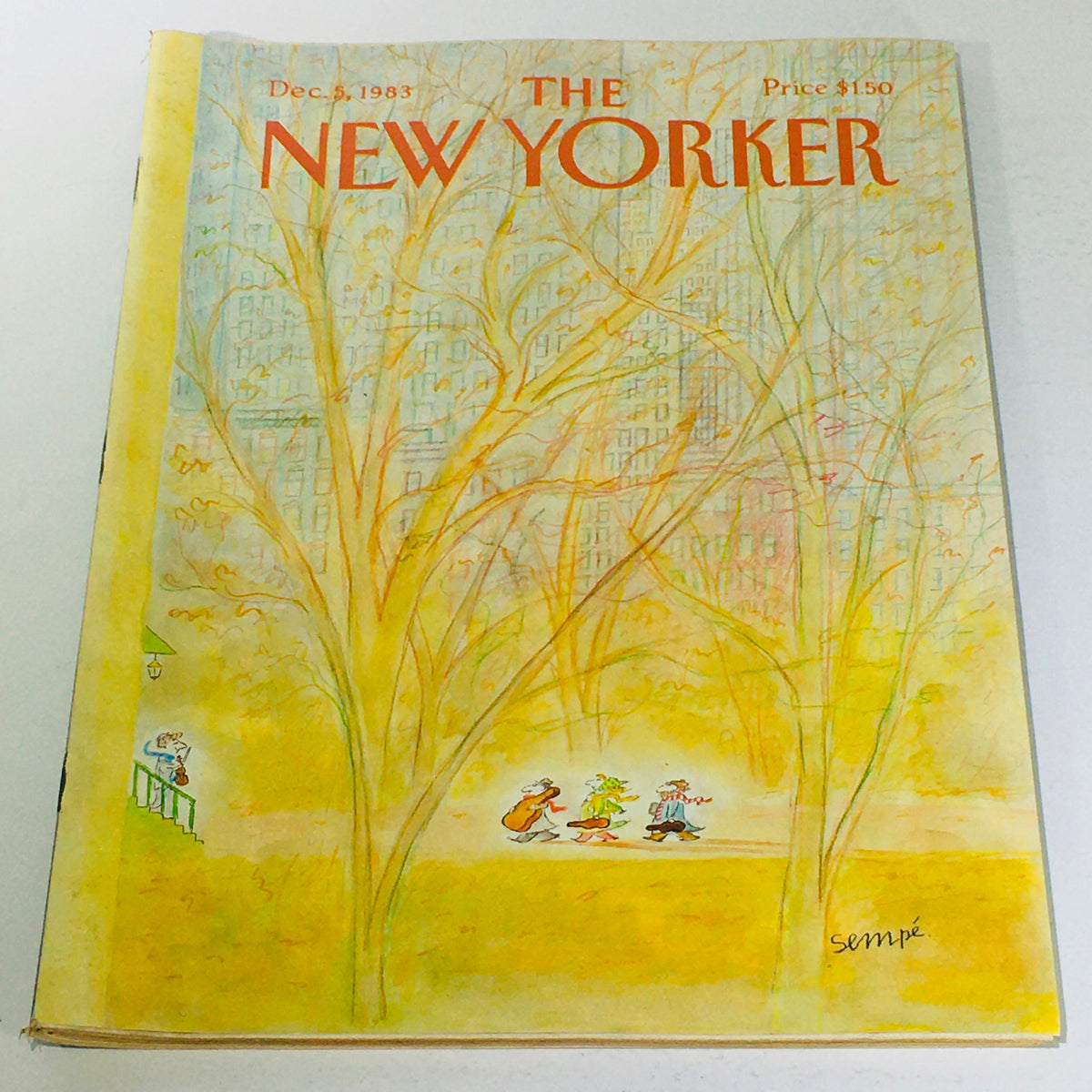 Cover of The New Yorker: December 5, 1983 featuring a joyful illustration by Jean-Jacques Sempe, depicting whimsical characters walking under autumn trees, encapsulating the charm of New York life with a vintage aesthetic.