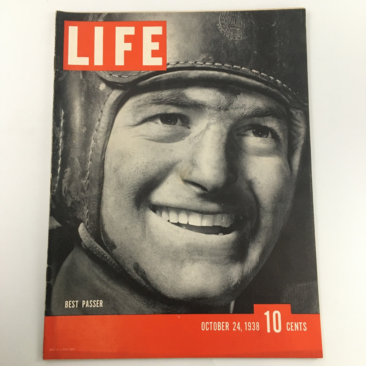 Cover of VTG Life Magazine from October 24, 1938, featuring best passer Sid Luckman, showcasing a vintage football theme with a close-up of Luckman's smiling face.