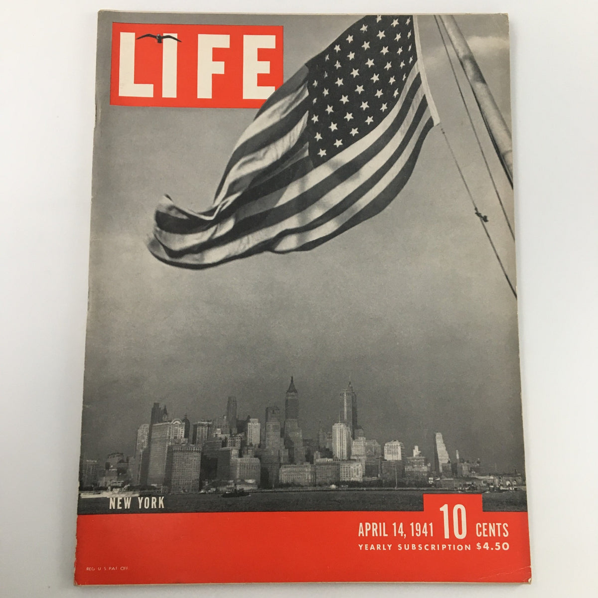 Cover of VTG Life Magazine April 14 1941, featuring an American flag and a skyline of New York City, reflecting the era's historical significance.