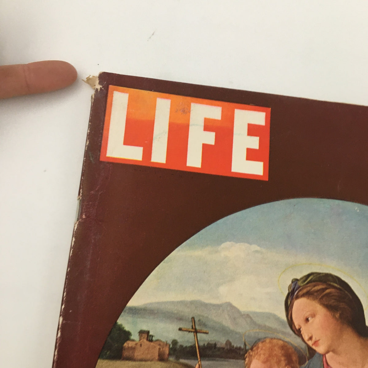 Close-up of the corner of the VTG Life Magazine December 28 1942, highlighting the cover art of Alba Madonna by Raphael and showing minor wear at the top edge.