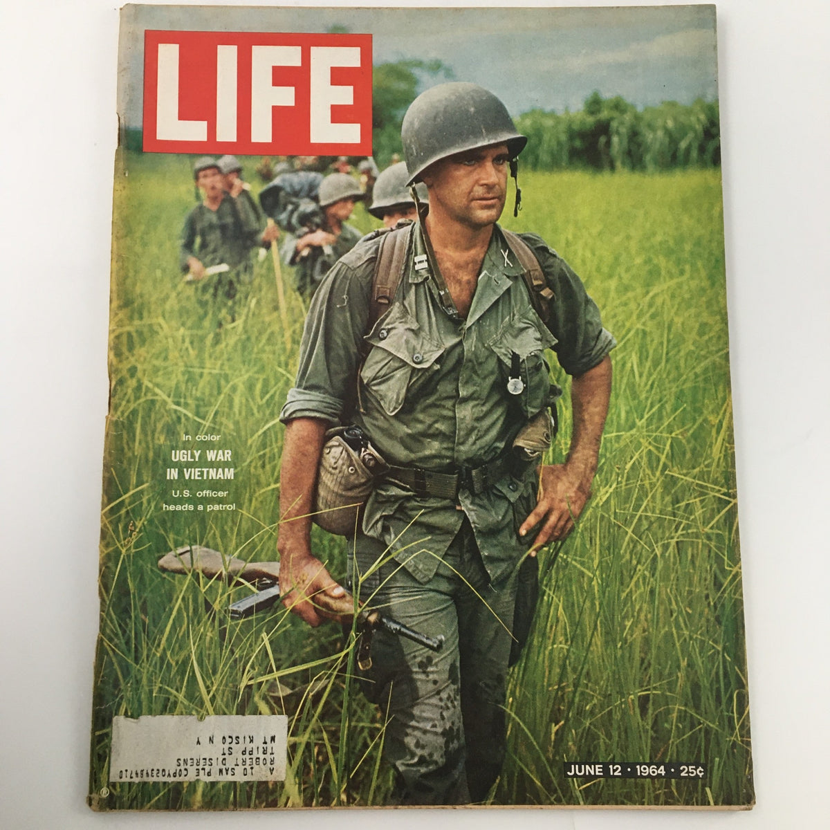 Vintage Life Magazine cover from June 12, 1964, featuring the title 'Ugly War in Vietnam' with a U.S. officer leading a patrol through tall grass, capturing a moment from the historical context of the Vietnam War.