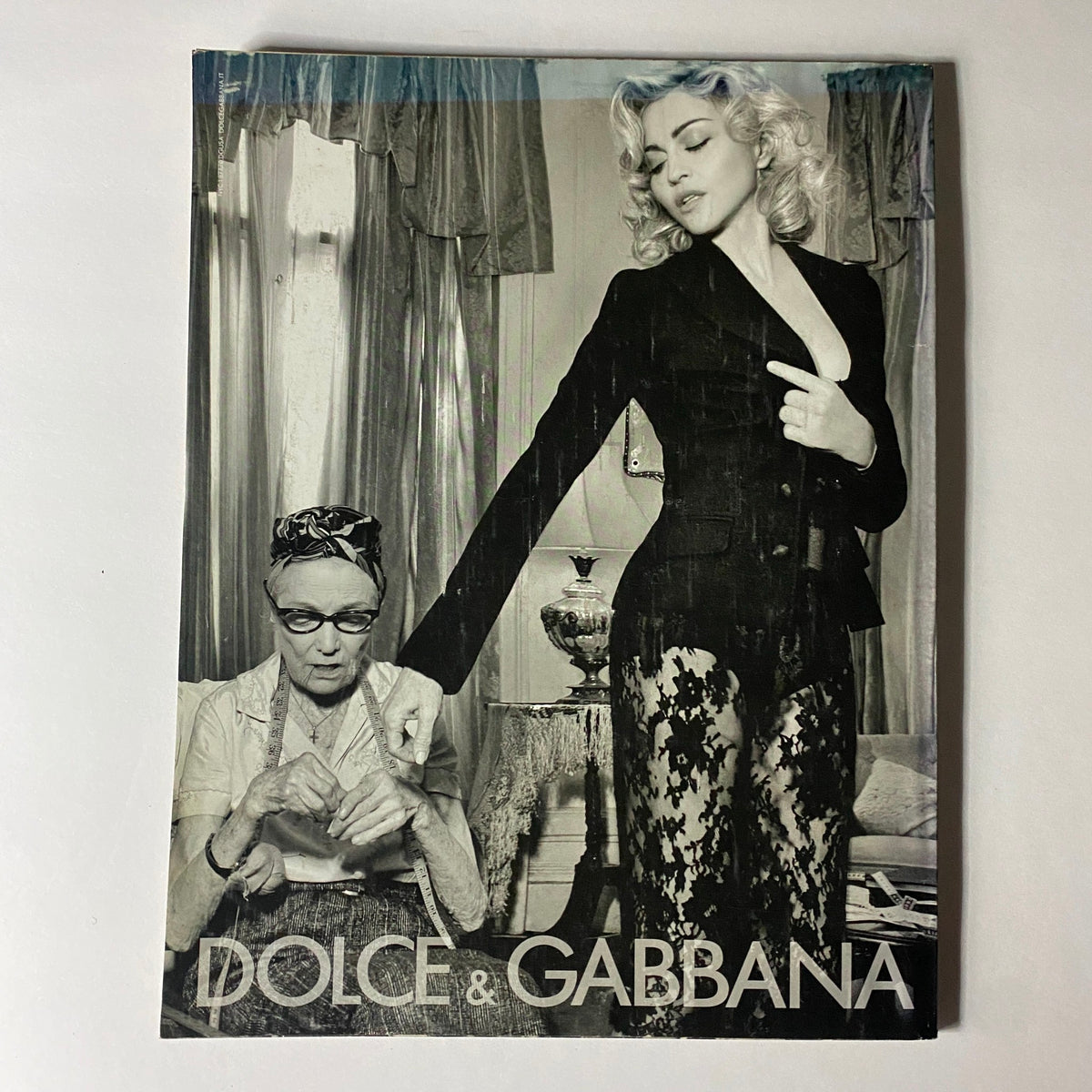 Stylized black and white fashion advertisement for Dolce & Gabbana, appearing in W Magazine August 2010, featuring a model and an elder woman.