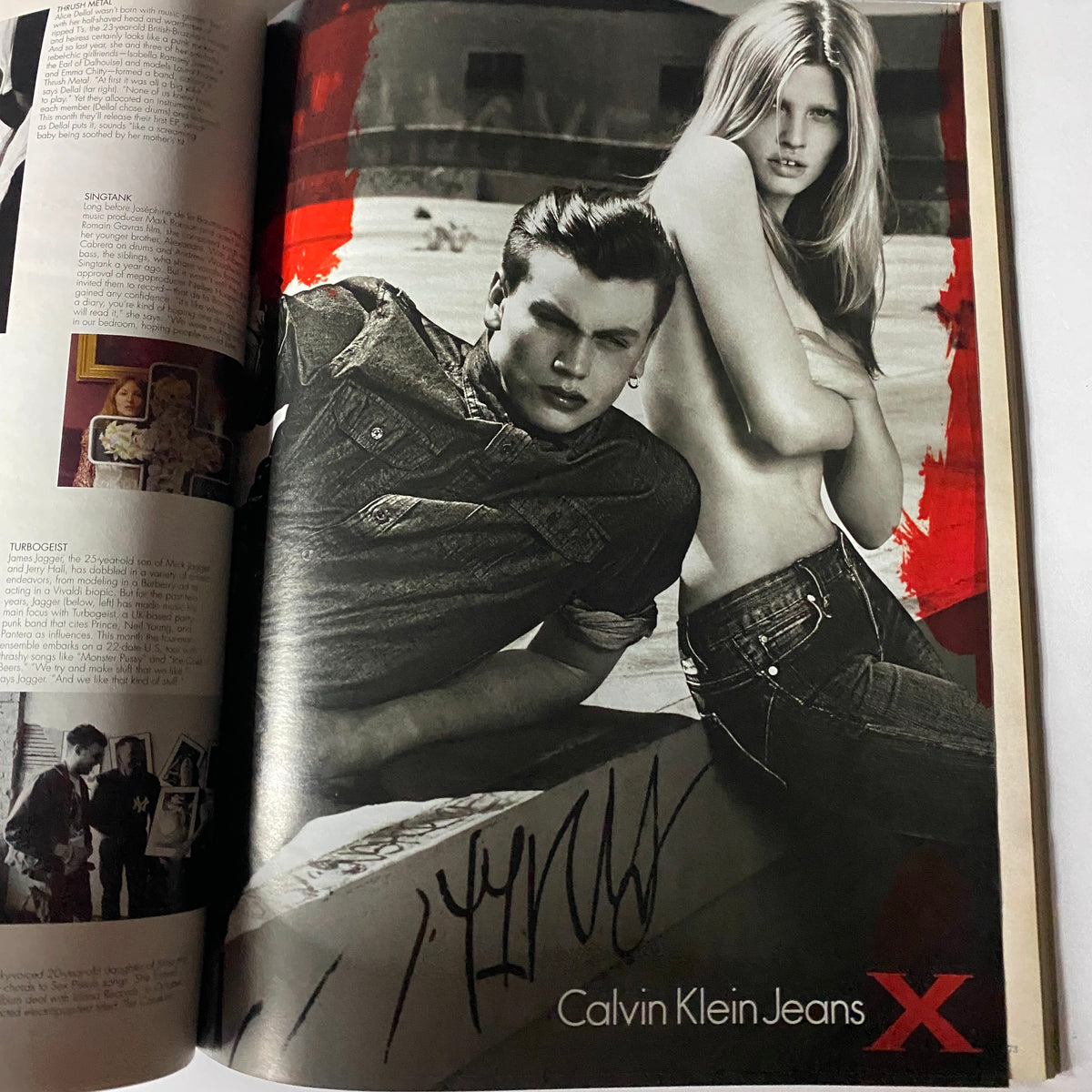W Magazine October 2010 featuring a striking black-and-white editorial image showcasing a male model and a female model for Calvin Klein Jeans, capturing contemporary fashion and celebrity culture.