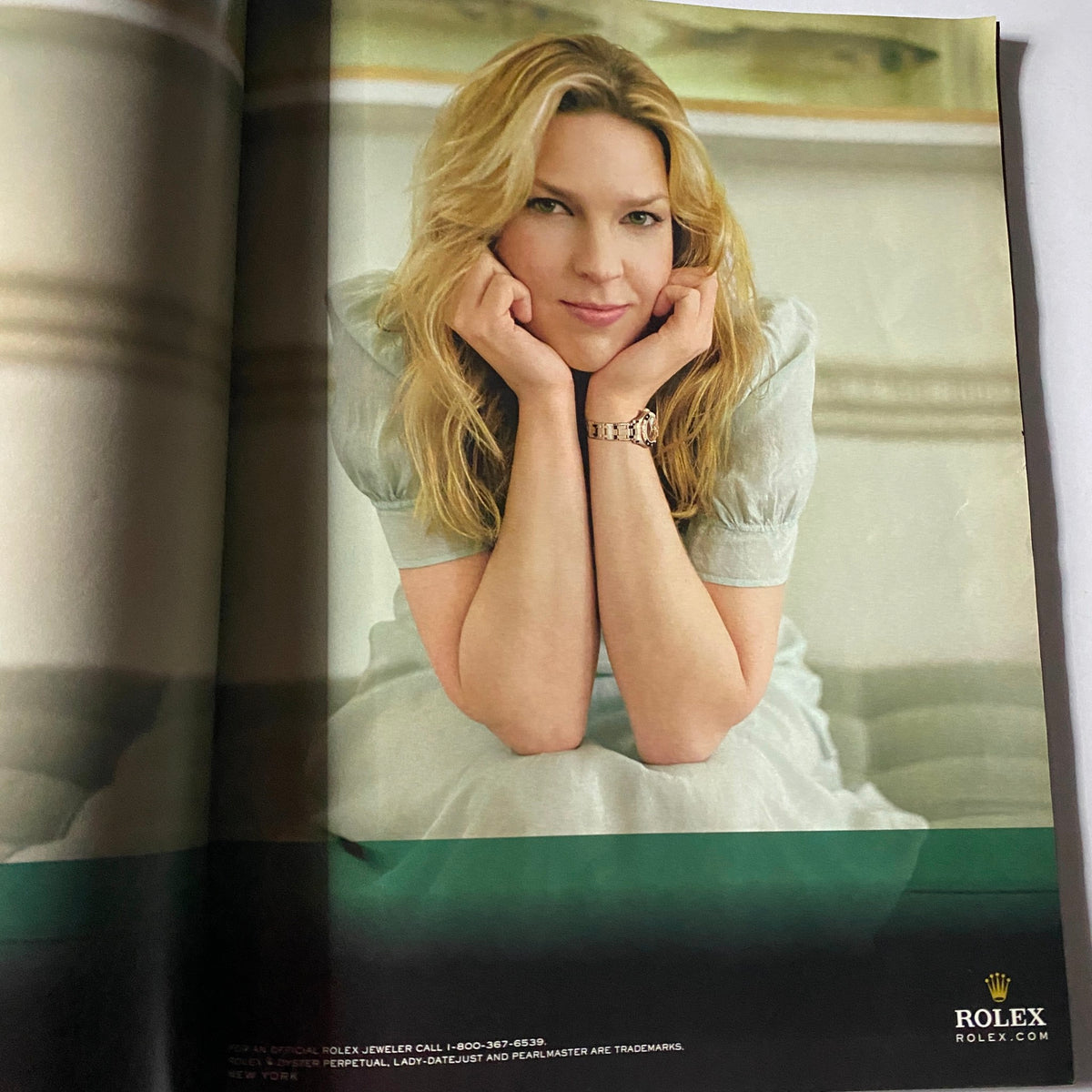 Advertisement featuring a woman with blonde hair, showcasing a Rolex watch, included in W Magazine's November 2010 issue with Kim Kardashian on the cover.