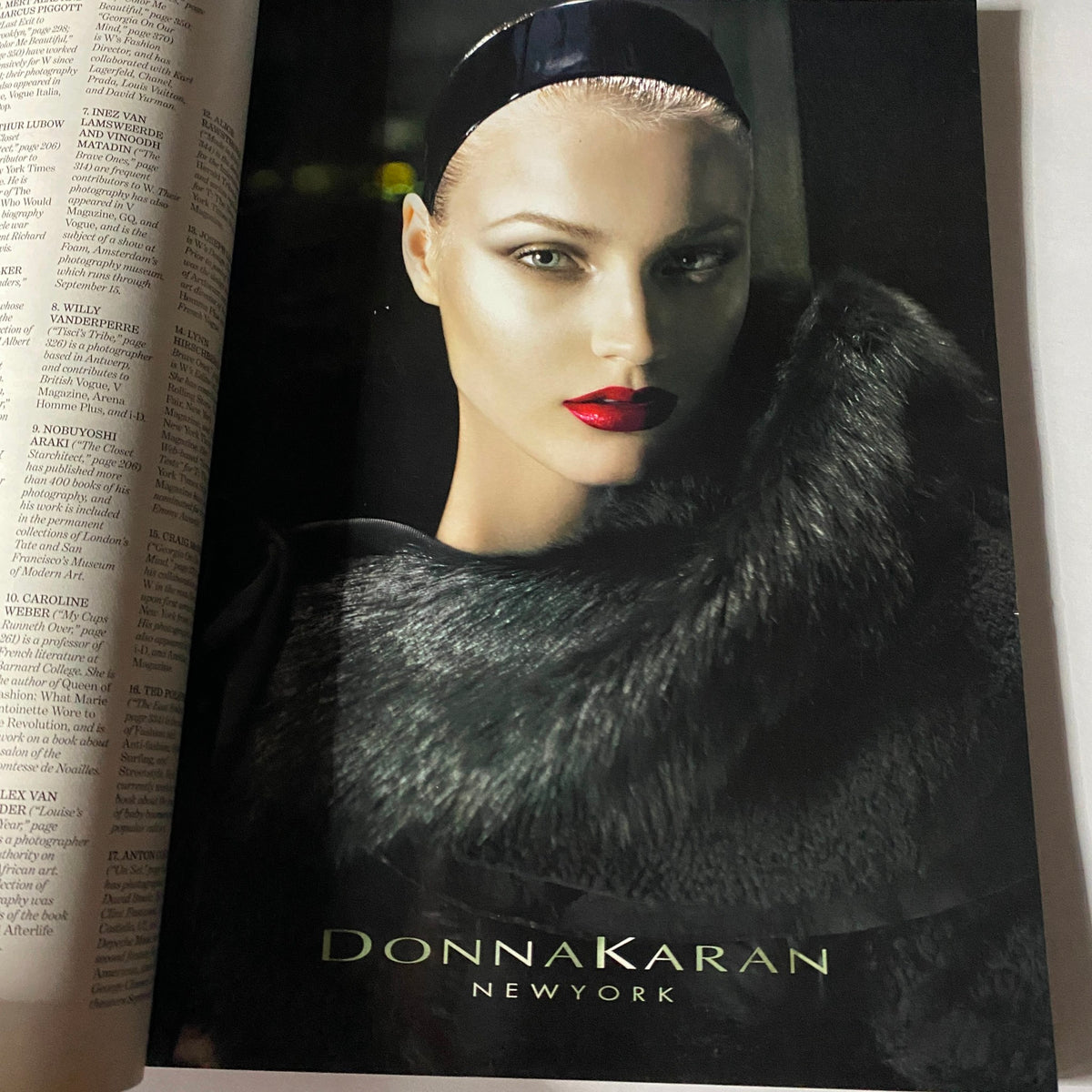 Fashion advertisement from W Magazine September 2010 showcasing a model in a Donna Karan New York apparel featuring luxurious fur and bold red lipstick.