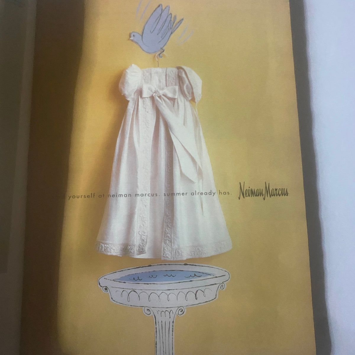 Advertisement from W Magazine June 1996 featuring an elegant white dress and a blue bird, promoting Neiman Marcus and highlighting summer fashion.