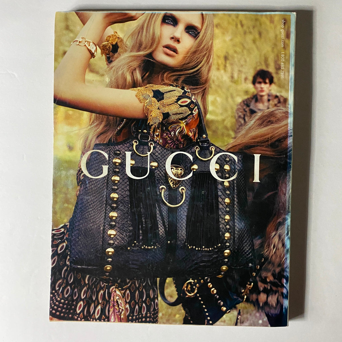 Vibrant Gucci advertisement featured in W Magazine October 2008, showcasing a model with a striking bag, encapsulating the bold fashion trends of the late 2000s.