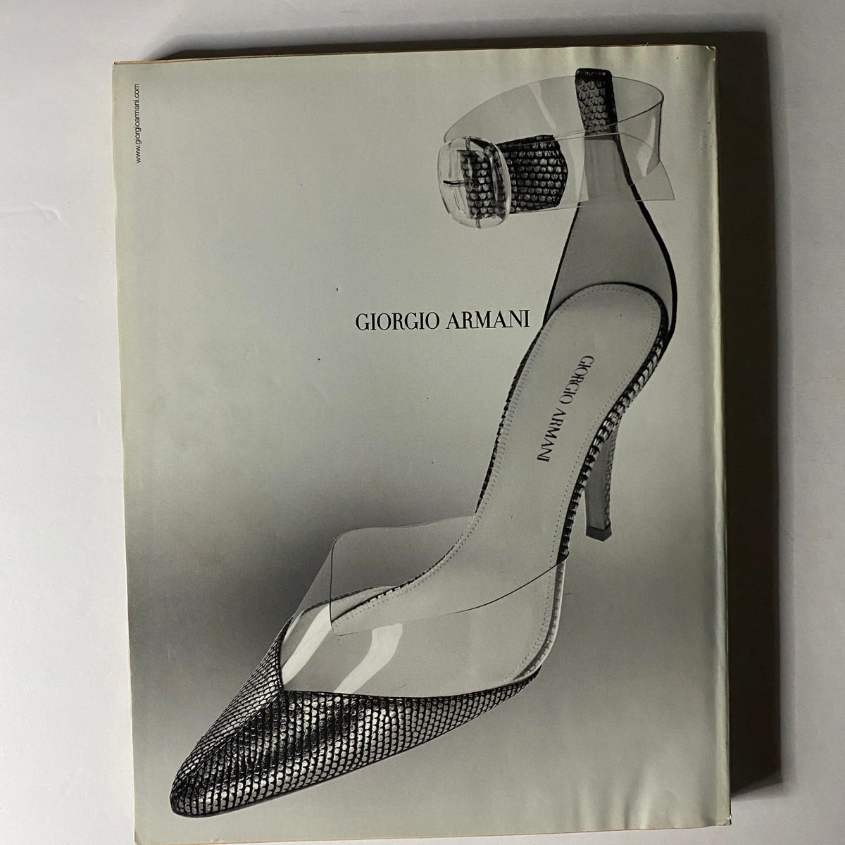 W Magazine March 2004 advertisement featuring a striking Giorgio Armani high-heeled shoe, epitomizing luxury fashion and design from the early 2000s.