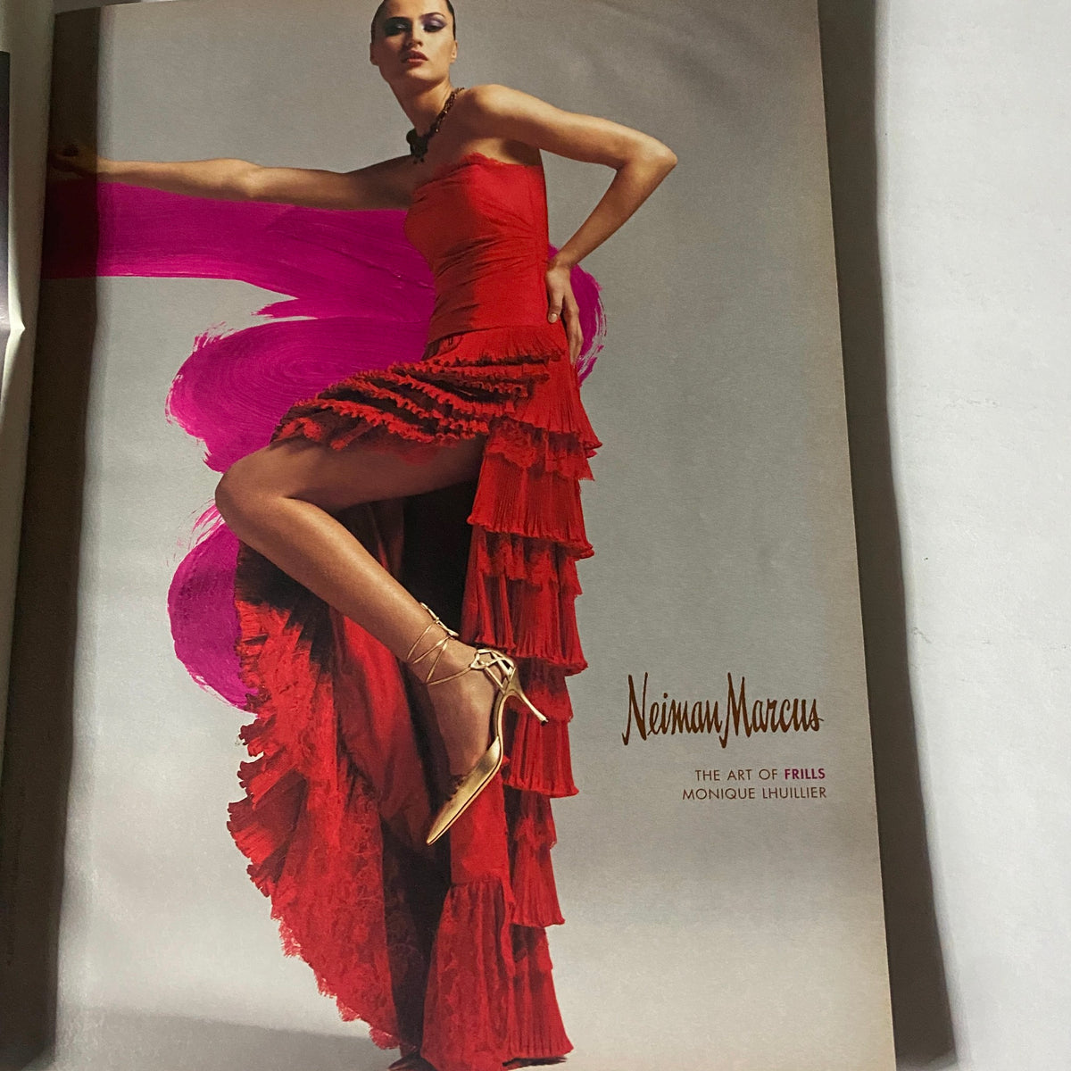 W Magazine August 2003 showcasing a bold red dress by Monique Lhuillier, emphasizing high fashion and modern styling.